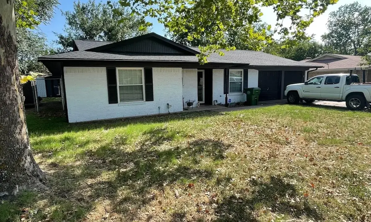 Professional roofing crew working on a residential roof in Eastman